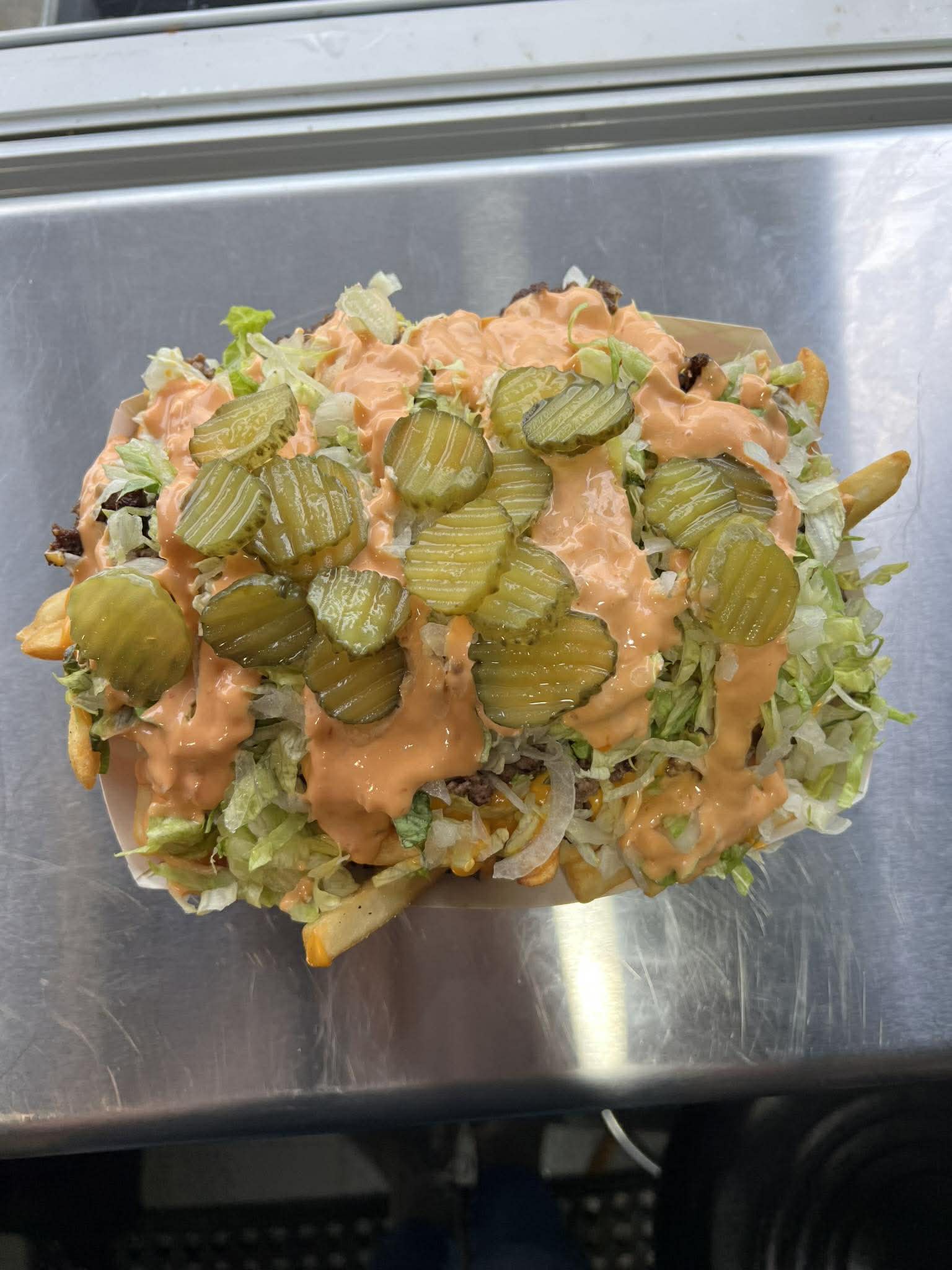 Overhead view of loaded fries with toppings